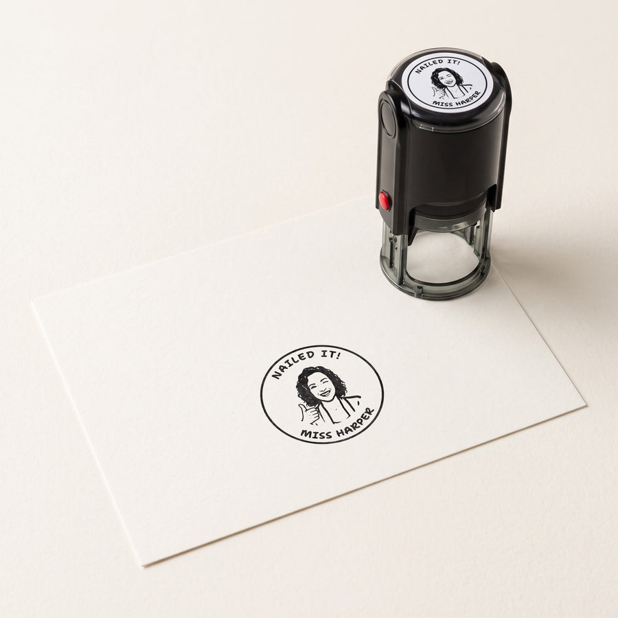 A personalised self-inking stamp with a teacher portrait design and its print on card