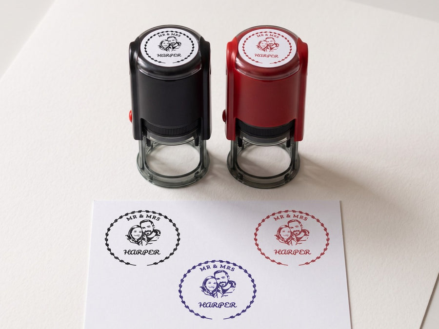 The stamp in a black case and a red case with a couple design on top, and the design printed in black, blue and red ink
