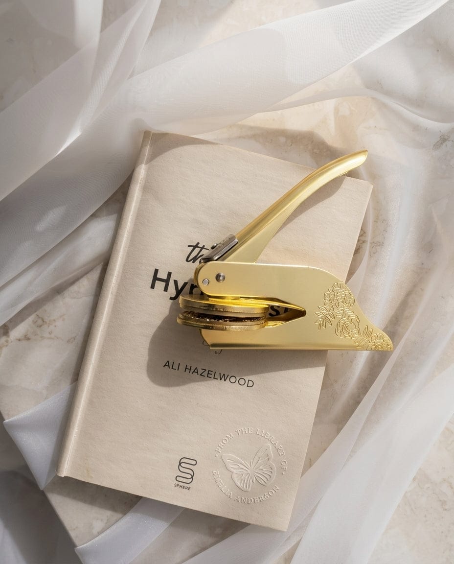 A brass book embosser in the Stamped Pages studio